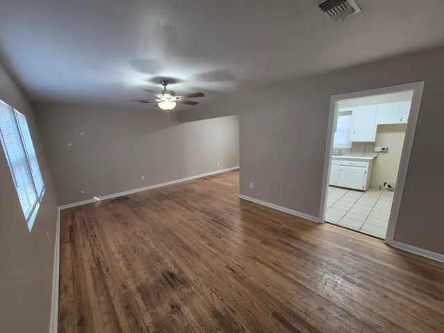 wooden floor in an empty room with a window
