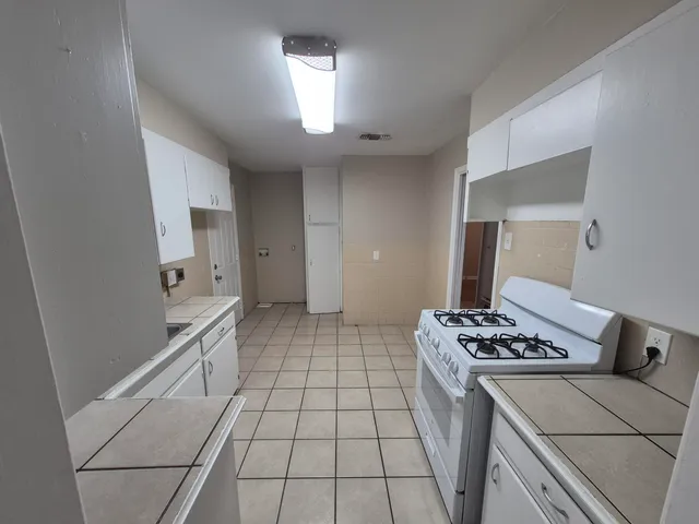 a kitchen with a stove and a refrigerator