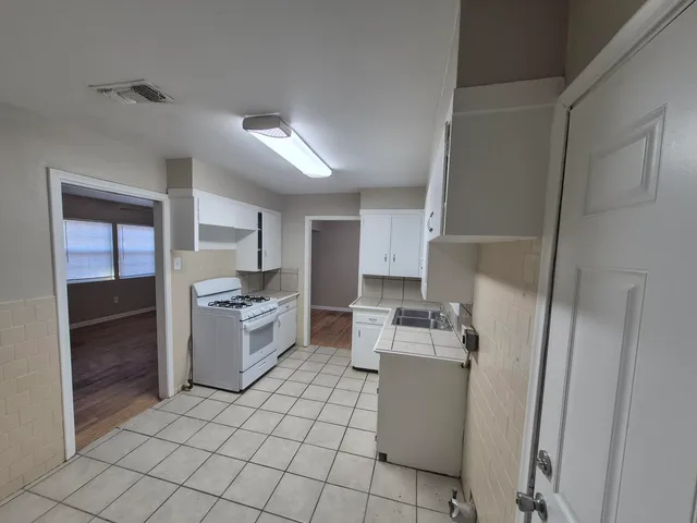 a kitchen with a sink cabinets and stainless steel appliances