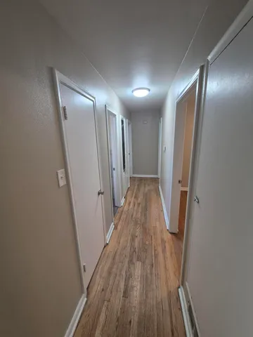 a view of hallway with wooden floor