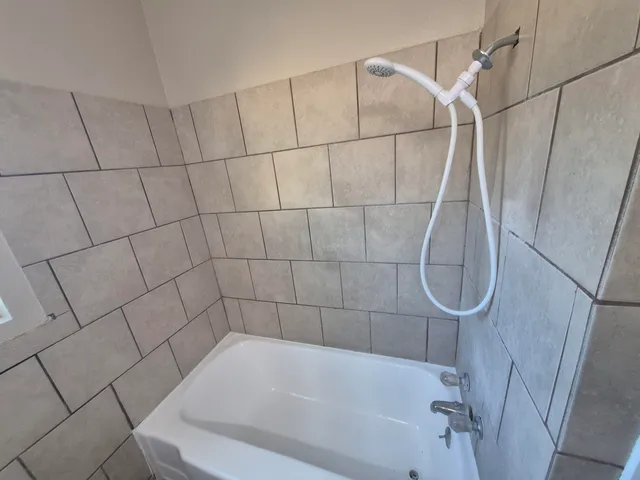 a bathroom with a bath tub and shower