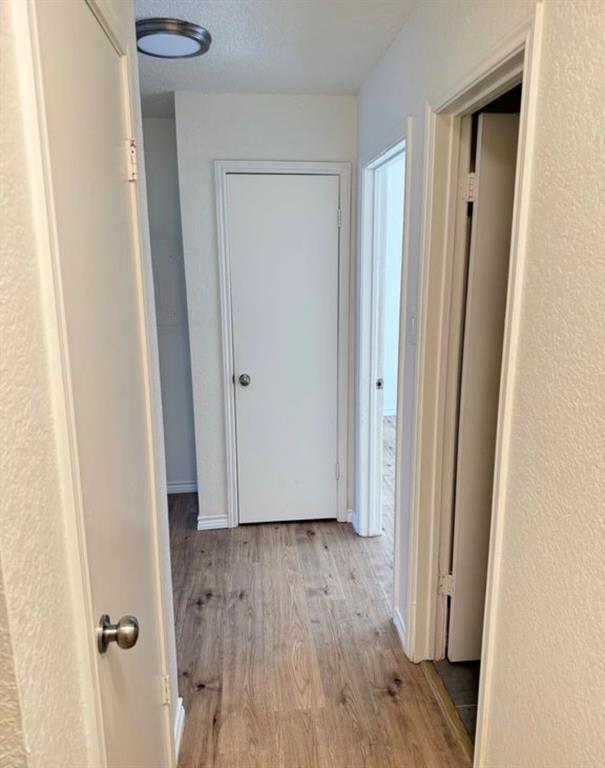8 Trails Place, Unit B Wylie, TX 75098 - Photo 12 of 24 a view of a hallway with wooden floor