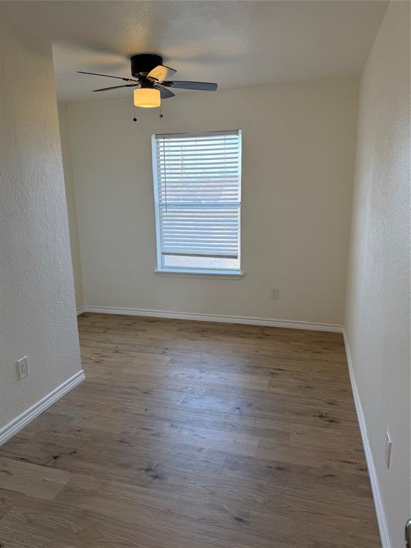 8 Trails Place, Unit B Wylie, TX 75098 - Photo 16 of 24 an empty room with wooden floor and window