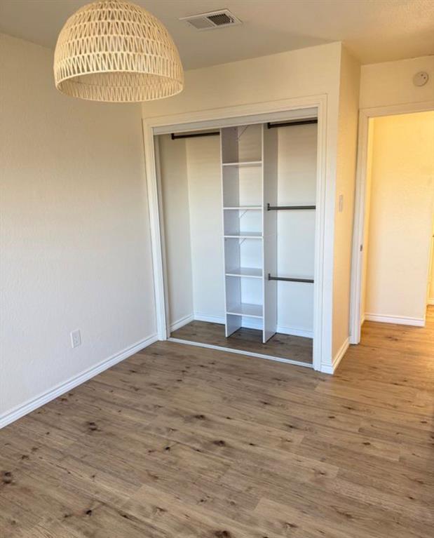 8 Trails Place, Unit B Wylie, TX 75098 - Photo 19 of 24 an empty room with wooden floor and windows