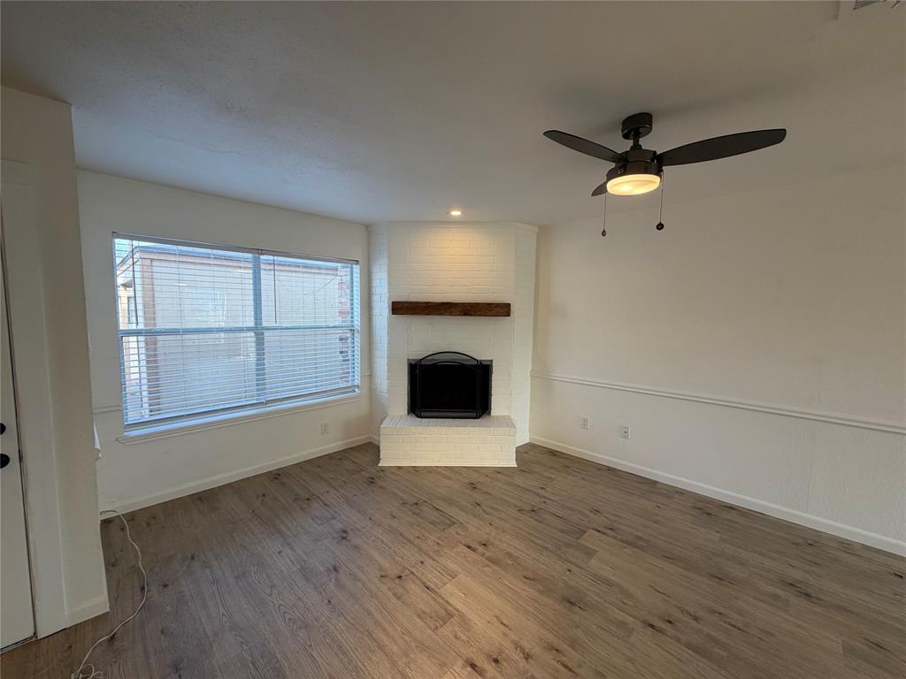 8 Trails Place, Unit B Wylie, TX 75098 - Photo 3 of 24 wooden floor in an empty room with a fireplace