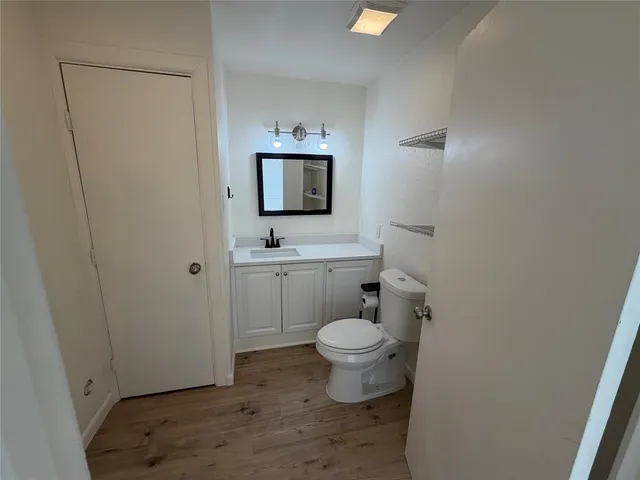 a bathroom with a toilet a sink and mirror