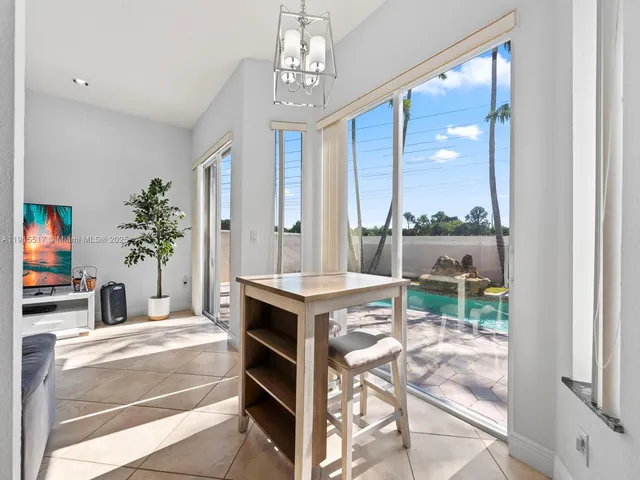 a living room with furniture a flat screen tv and a window