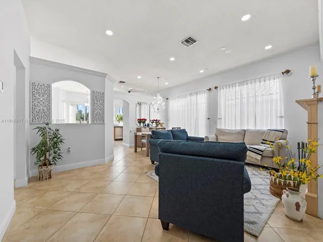 a kitchen with stainless steel appliances granite countertop a refrigerator sink and stove