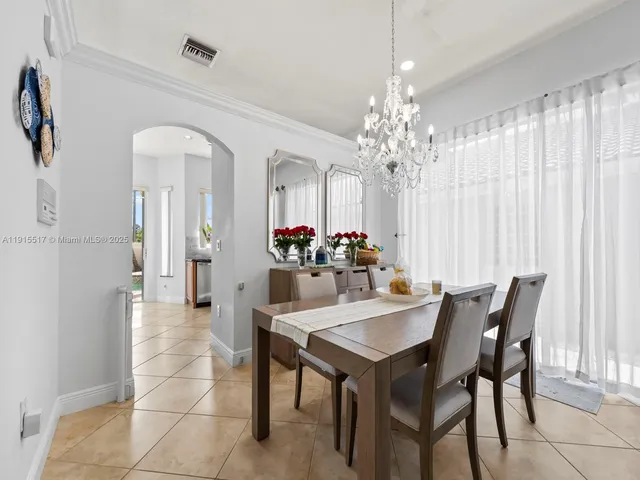 a kitchen with a refrigerator a stove top oven a sink dishwasher and wooden cabinets