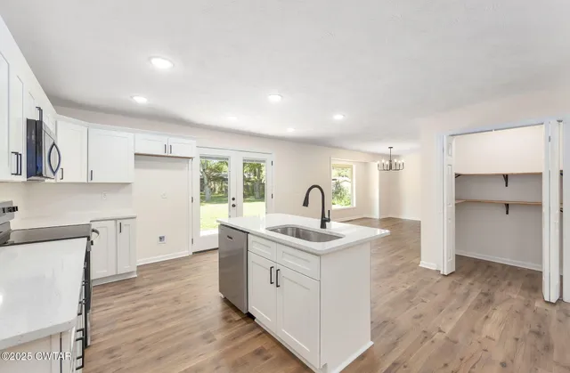a kitchen with a sink stove and cabinets