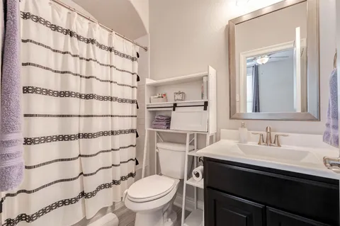 a bathroom with a sink toilet and shower