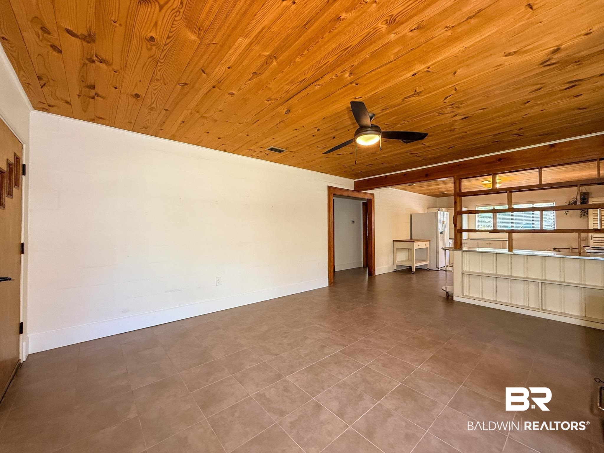 18711 Keller Road Foley, AL 36535 - Photo 8 of 38 Living area featuring a natural wood plank ceiling, a ceiling fan with integrated lighting, and tile flooring