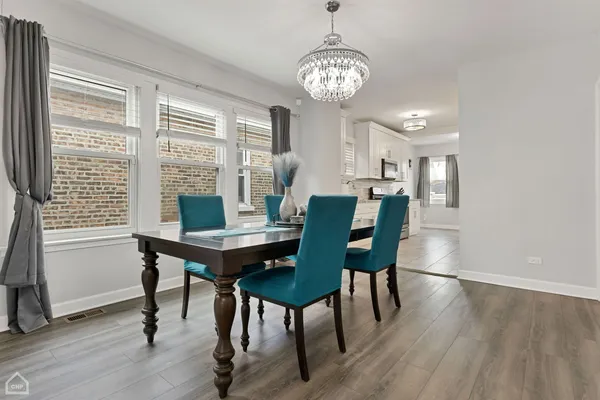 a view of a dining room with furniture window and wooden floor