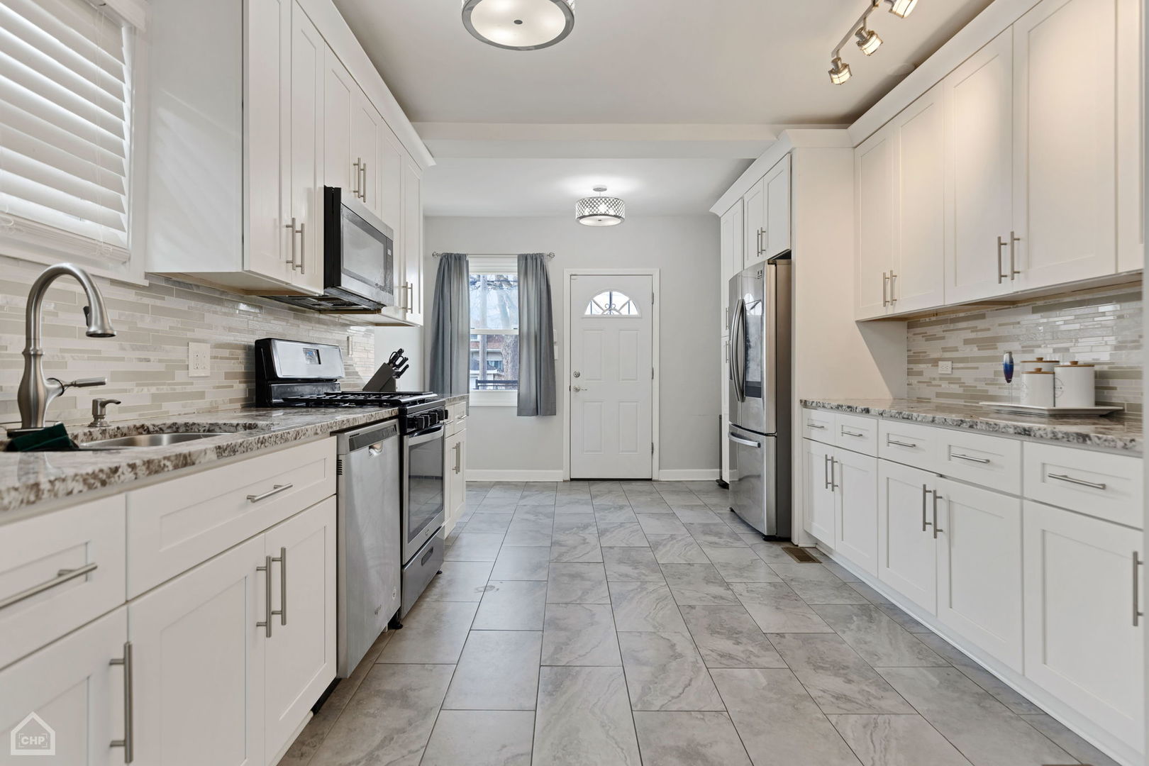9320 South Racine Avenue Chicago, IL 60620 - Photo 7 of 25 a kitchen with granite countertop a sink and cabinets