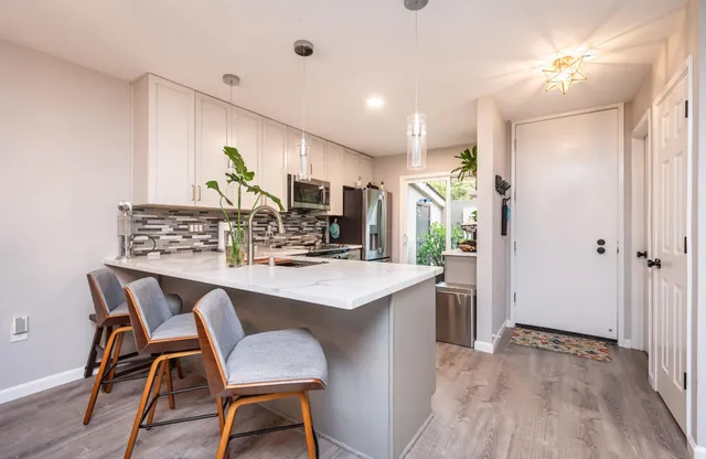 a view of a dining room with furniture and wooden floor