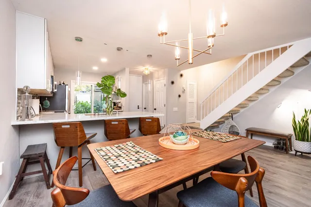 a living room with patio furniture and a floor to ceiling window