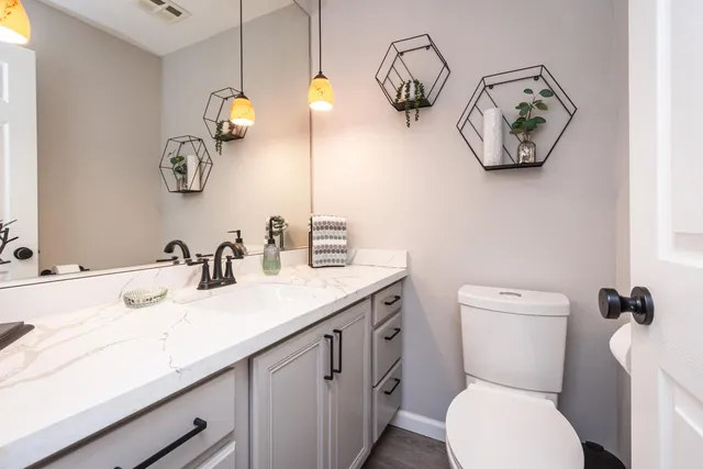 a bedroom with bed and a potted plant