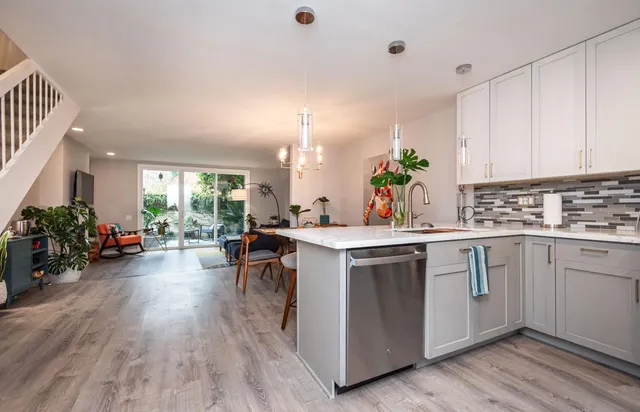 a kitchen with a sink stove and cabinets