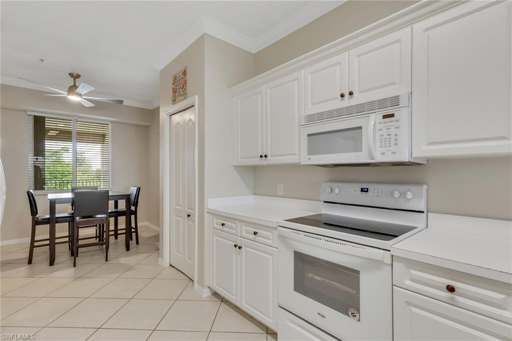 8570 Kingbird Loop, Unit 542 Estero, FL 33967 - Photo 15 of 43 a kitchen with white cabinets and white appliances
