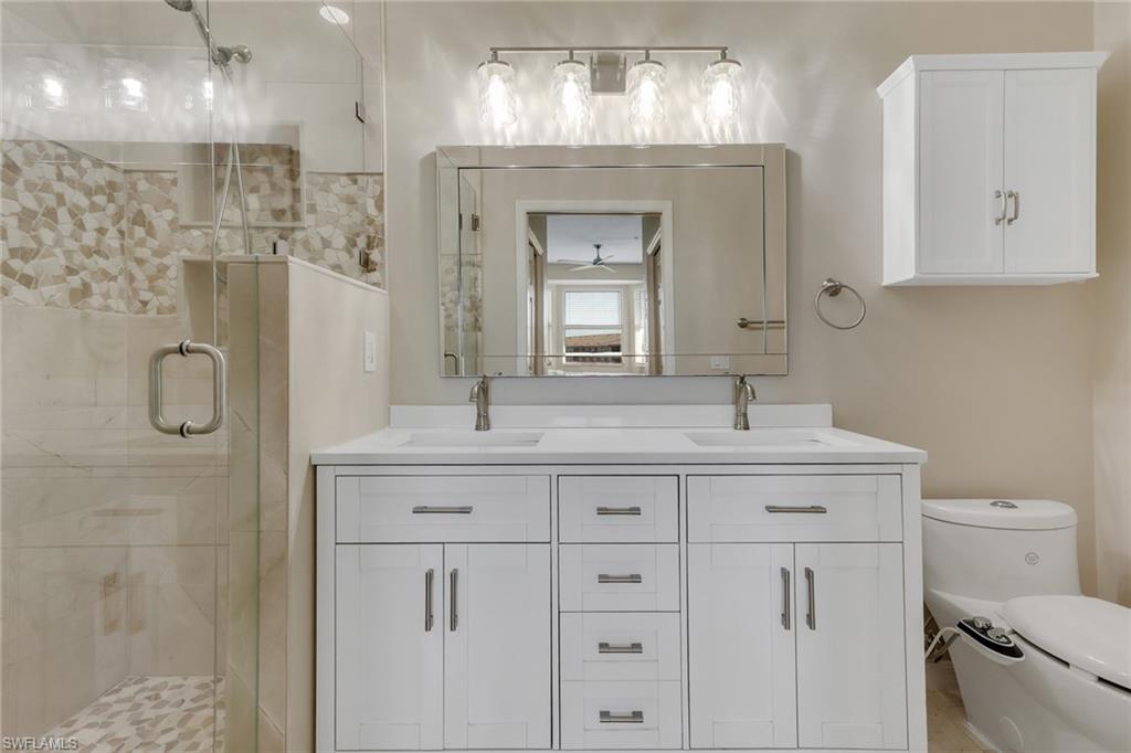 8570 Kingbird Loop, Unit 542 Estero, FL 33967 - Photo 21 of 43 a bathroom with a double vanity sink mirror and toilet