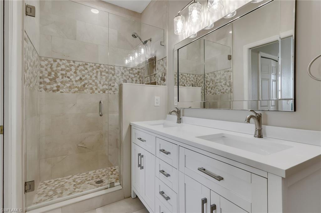 8570 Kingbird Loop, Unit 542 Estero, FL 33967 - Photo 22 of 43 a bathroom with a sink and a mirror
