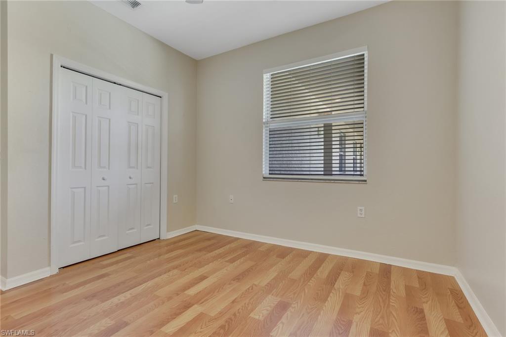 8570 Kingbird Loop, Unit 542 Estero, FL 33967 - Photo 26 of 43 a view of an empty room with wooden floor and a window