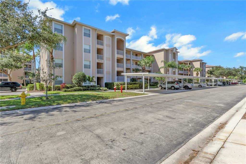 8570 Kingbird Loop, Unit 542 Estero, FL 33967 - Photo 32 of 43 a view of a building with a yard