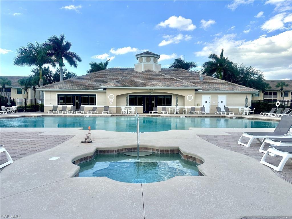 8570 Kingbird Loop, Unit 542 Estero, FL 33967 - Photo 35 of 43 a view of a house with a swimming pool and a chairs