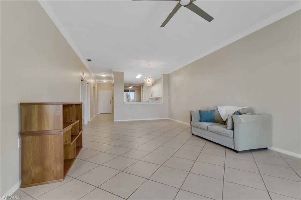 8570 Kingbird Loop, Unit 542 Estero, FL 33967 - Photo 8 of 43 a living room with furniture and a refrigerator