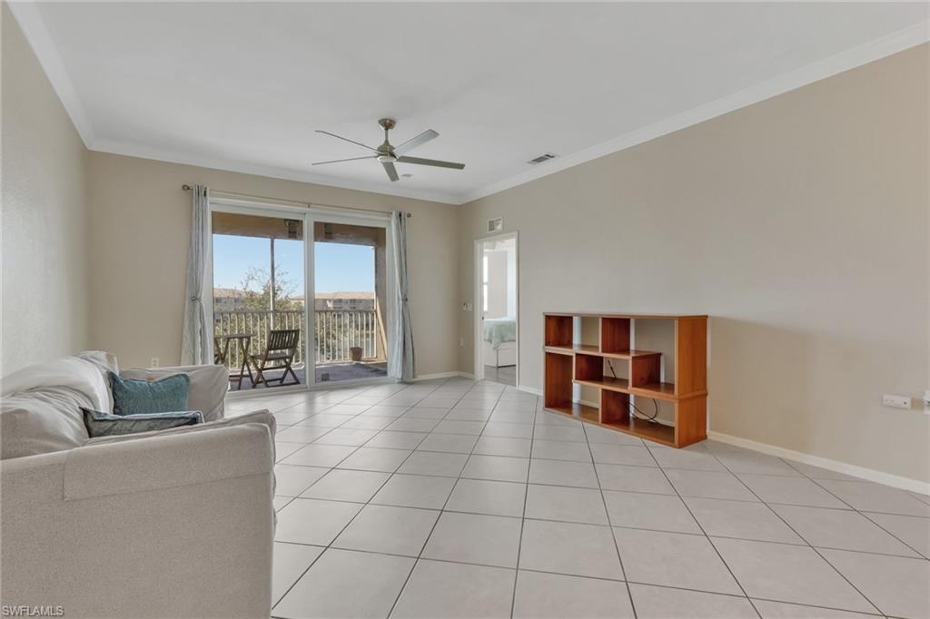 8570 Kingbird Loop, Unit 542 Estero, FL 33967 - Photo 9 of 43 a living room with furniture and large windows