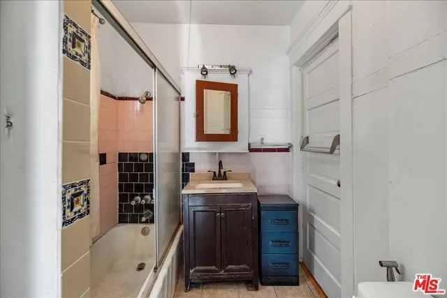 a bathroom with a granite countertop sink a vanity and a blue