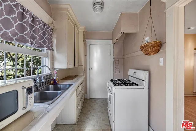 a kitchen with a stove and a refrigerator