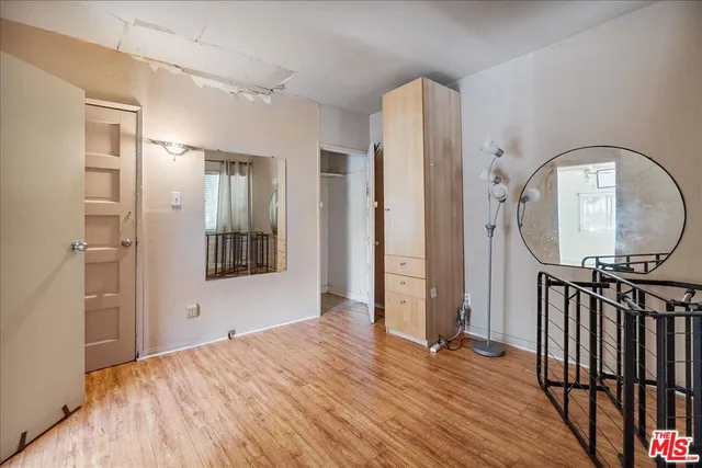 a view of a room with wooden floor and entryway