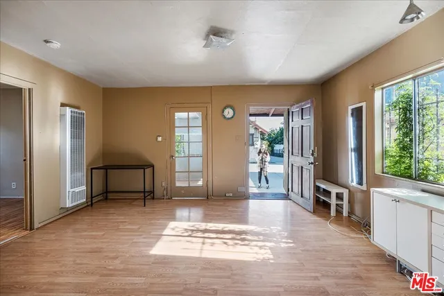 a view of a livingroom with furniture window and wooden floor