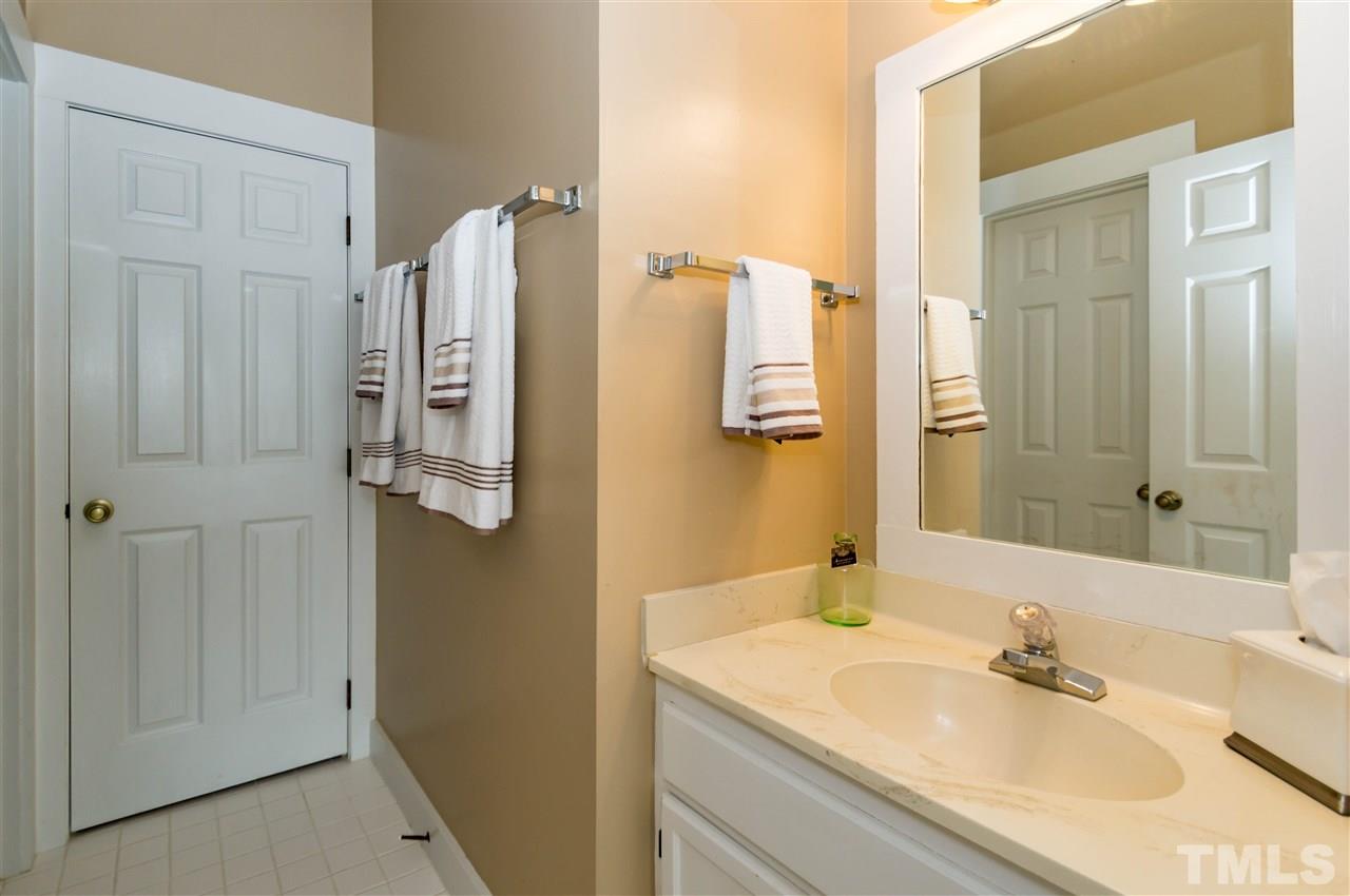 6038 Sentinel Drive Raleigh, NC 27609 - Photo 13 of 24 a bathroom with a sink and mirror