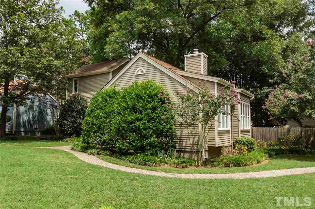6038 Sentinel Drive Raleigh, NC 27609 - Photo 23 of 24 a front view of a house with a yard and trees