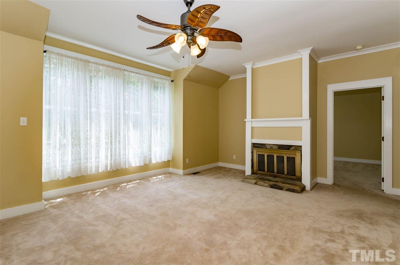 6038 Sentinel Drive Raleigh, NC 27609 - Photo 4 of 24 a view of a livingroom with a fireplace and entryway