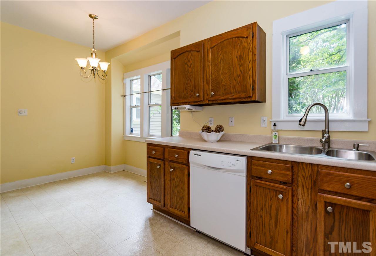 6038 Sentinel Drive Raleigh, NC 27609 - Photo 8 of 24 a kitchen with a sink cabinets and window