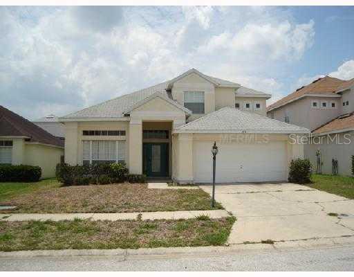 715 Riggs Circle Davenport, FL 33897 - Photo 1 of 1 a front view of a house with a yard