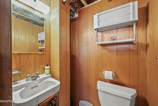 a bathroom with a sink toilet and mirror