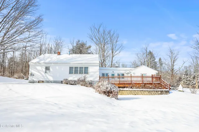 a view of a house with snow on the road