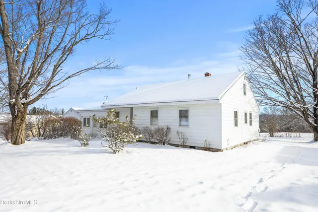 a view of a house with snow on the yard