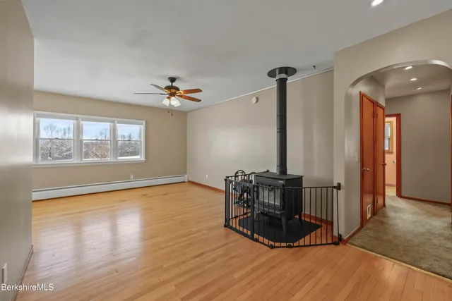 a view of a room with wooden floor and a window