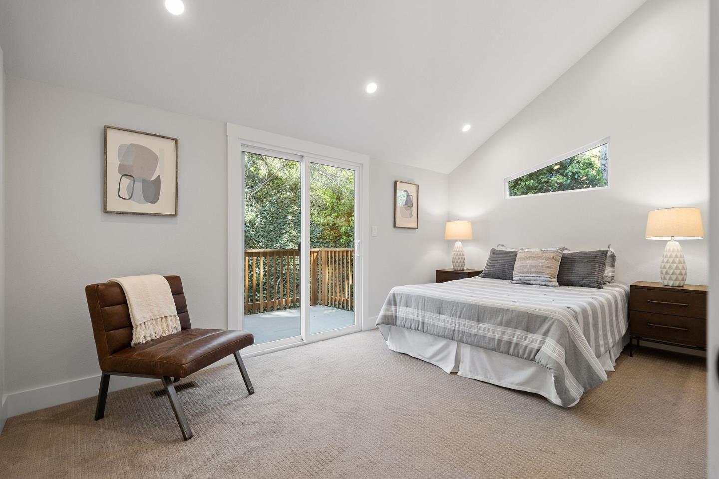 311 Keith Avenue Pacifica, CA 94044 - Photo 19 of 40 a spacious bedroom with a bed and a chair