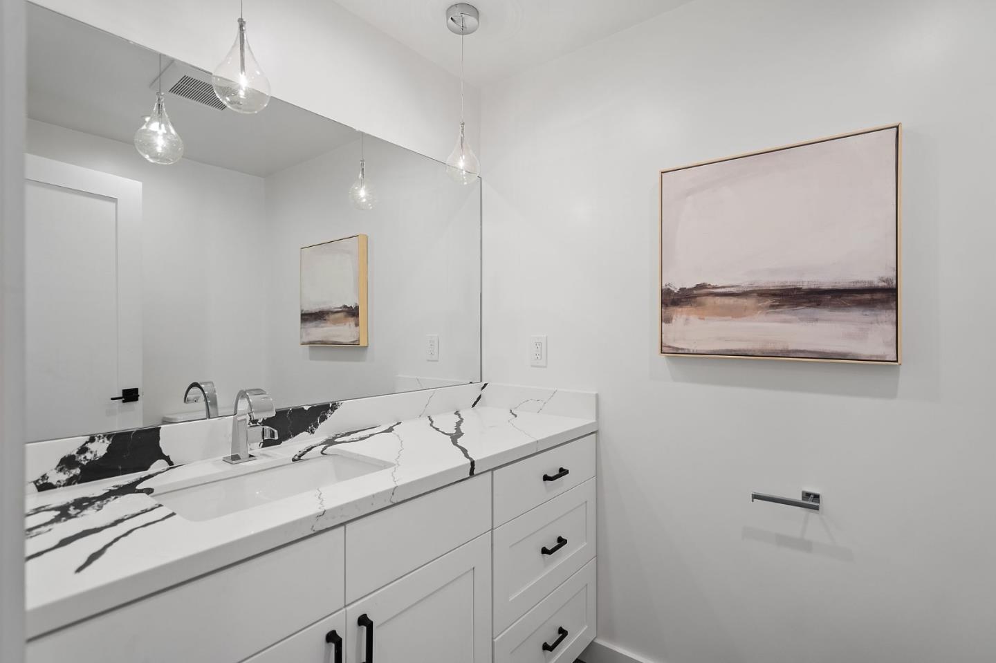 311 Keith Avenue Pacifica, CA 94044 - Photo 24 of 40 a bathroom with a double vanity sink and a mirror
