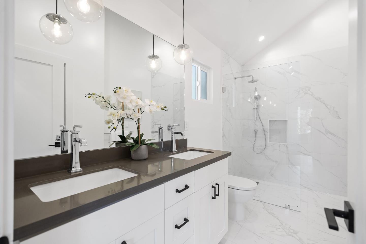 311 Keith Avenue Pacifica, CA 94044 - Photo 26 of 40 a bathroom with a granite countertop sink a large mirror and shower