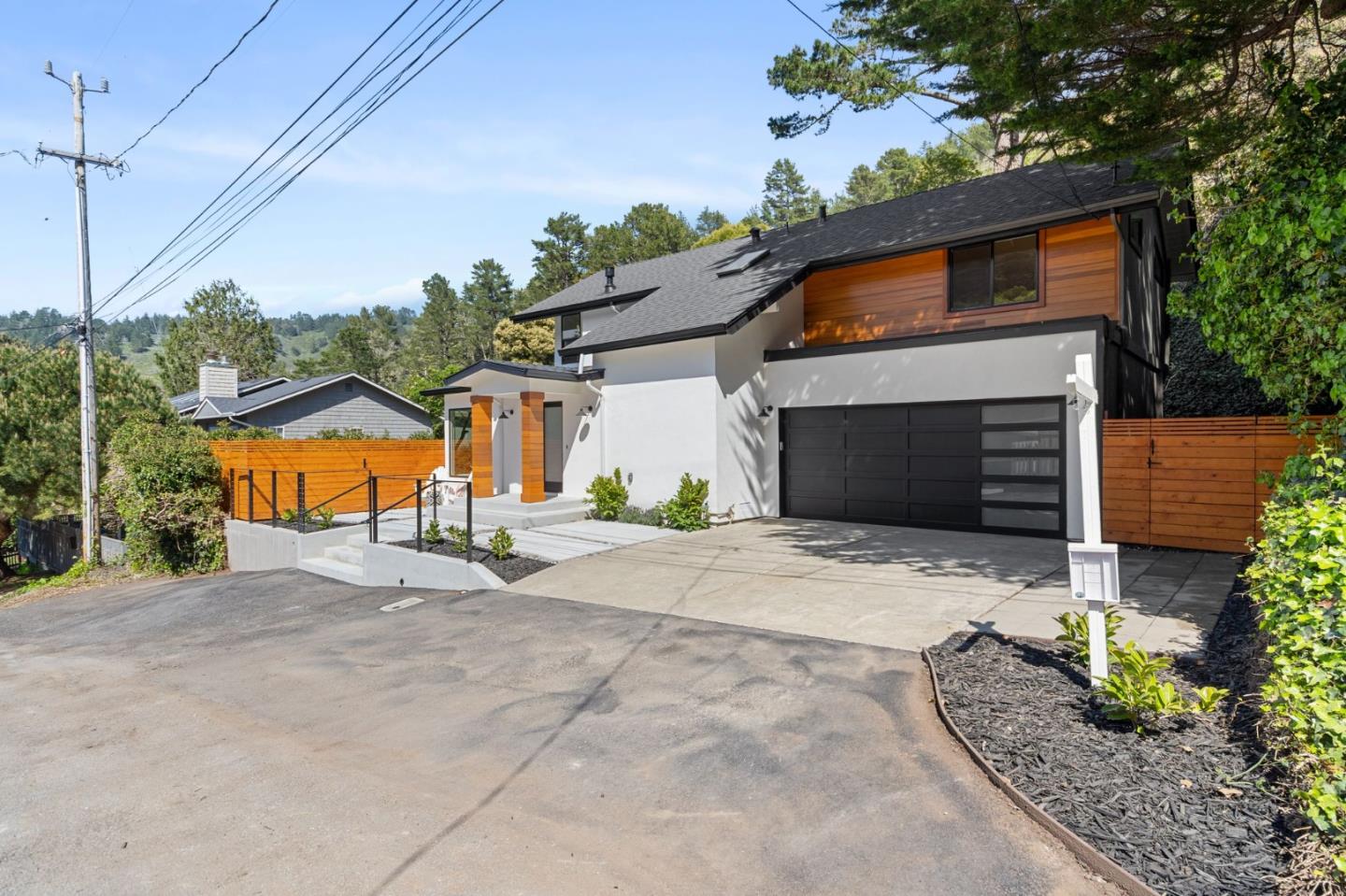 311 Keith Avenue Pacifica, CA 94044 - Photo 5 of 40 a front view of a house with a yard and garage