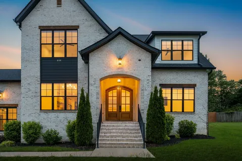 a front view of a house with large windows