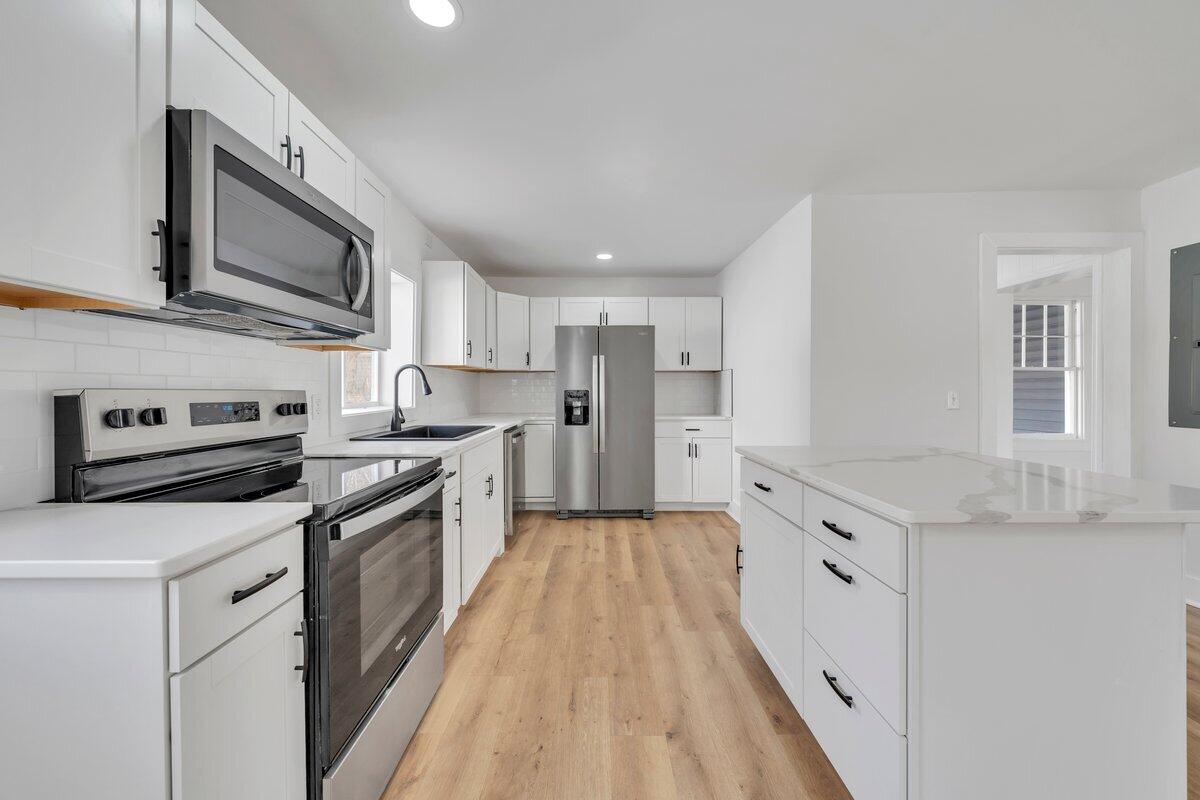 3808 Oldtown Road Shawsville, VA 24162 - Photo 12 of 50 a large kitchen with stainless steel appliances granite countertop a stove and a sink