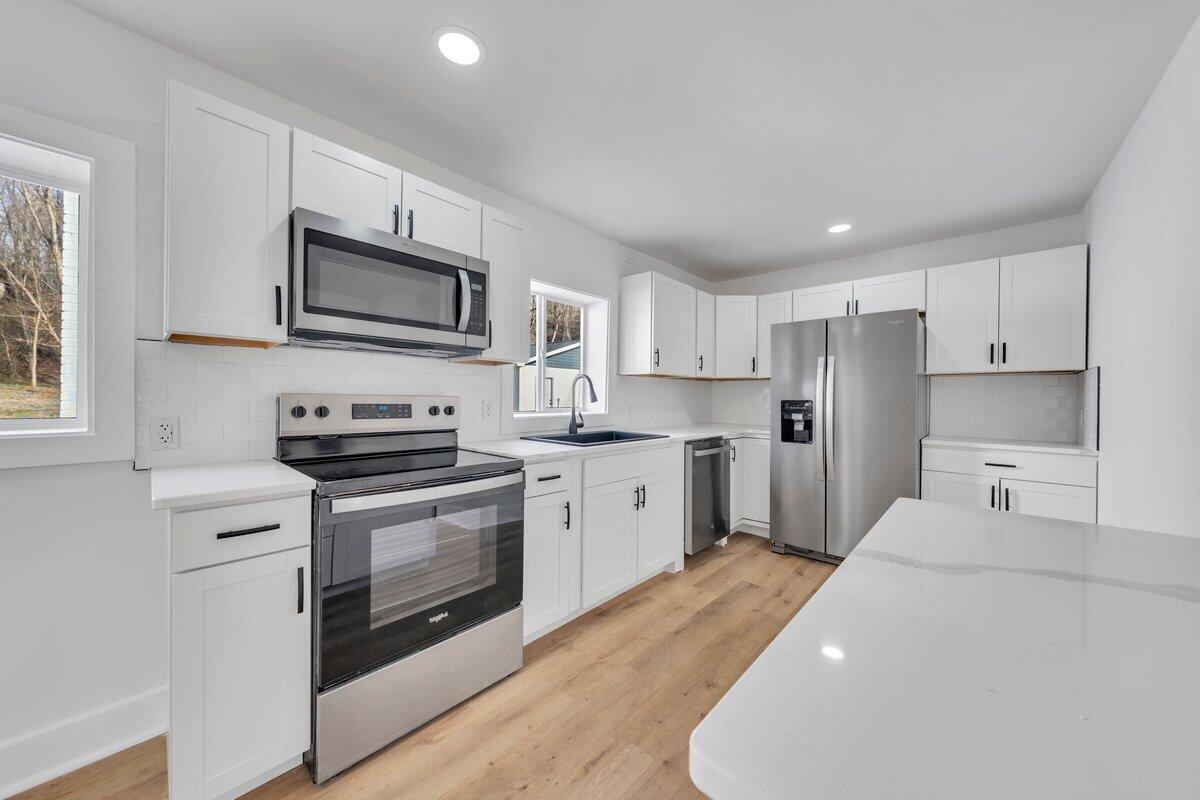 3808 Oldtown Road Shawsville, VA 24162 - Photo 13 of 50 a kitchen with cabinets stainless steel appliances and a sink